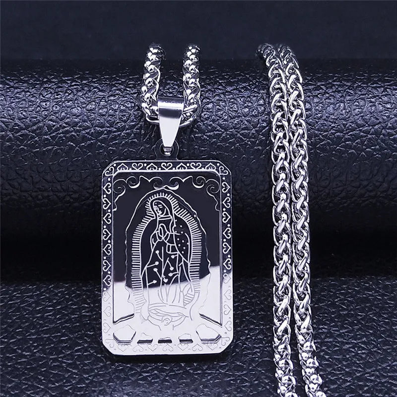 Silver pendant with engraved design on a textured black surface
