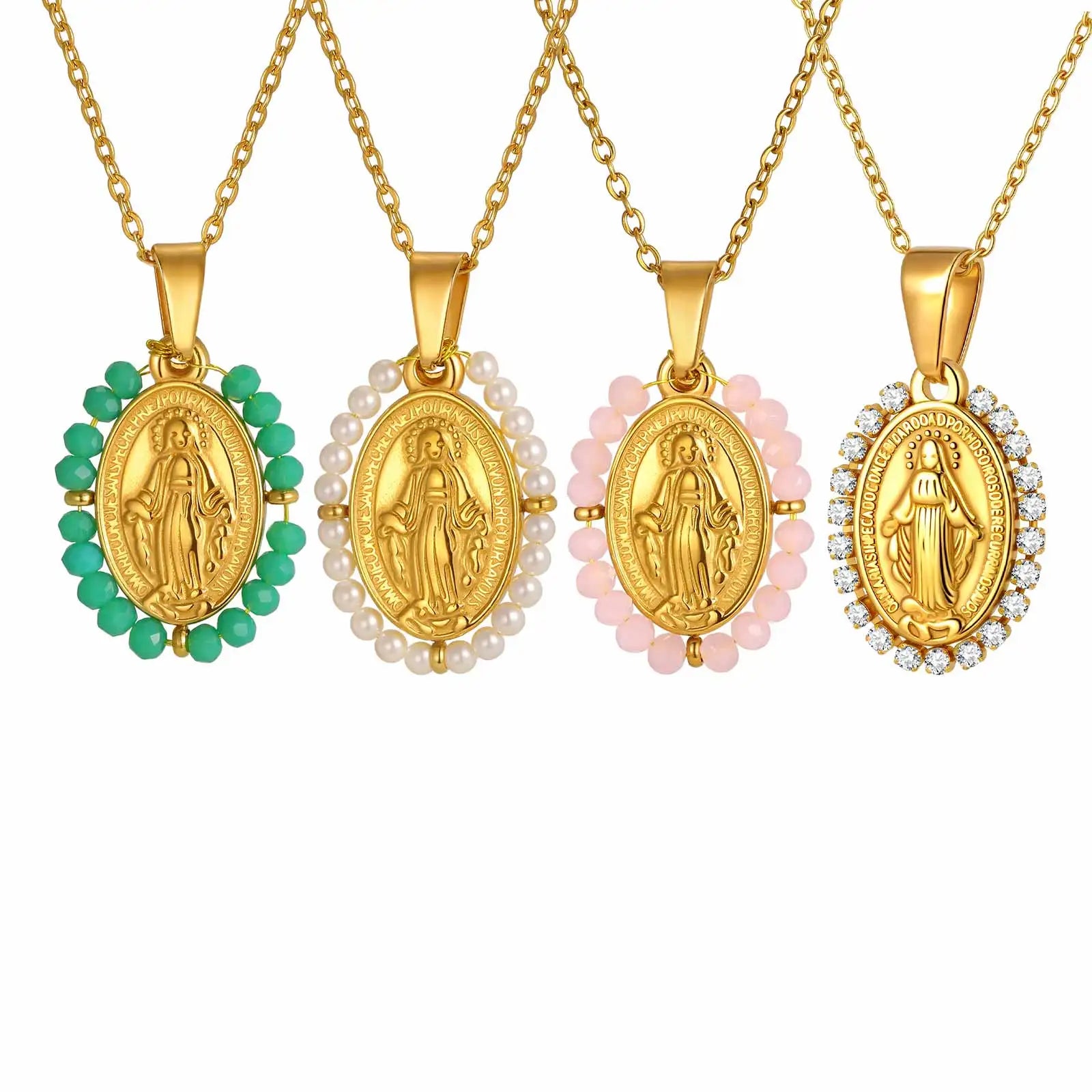 Four gold necklaces with religious pendants on a white background